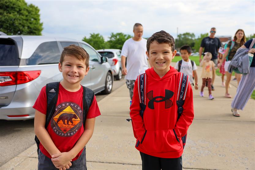 Two students smile
